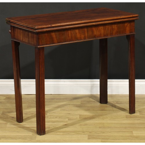 1303 - A George III mahogany card table, hinged top enclosing a baize lined playing surface, moulded intern... 