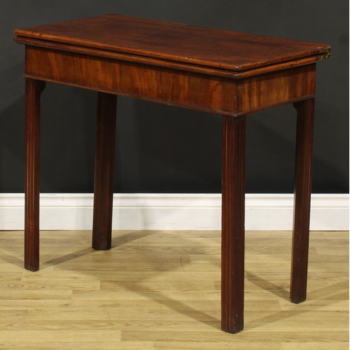 1303 - A George III mahogany card table, hinged top enclosing a baize lined playing surface, moulded intern... 