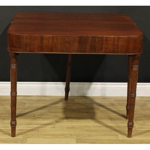 1253 - A 19th century mahogany tea table, hinged top with reeded edge above a deep frieze, ring-turned legs... 