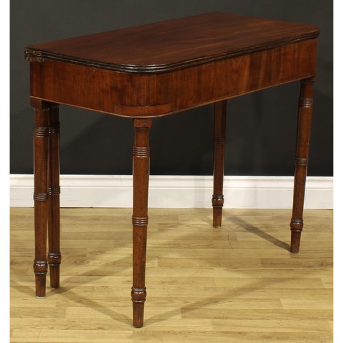 1253 - A 19th century mahogany tea table, hinged top with reeded edge above a deep frieze, ring-turned legs... 