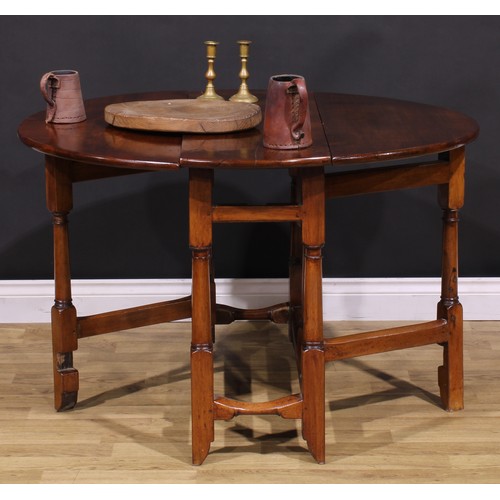 1278 - A 17th century style fruitwood gateleg table, oval top with fall leaves, turned and blocked supports... 