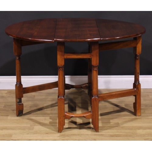 1278 - A 17th century style fruitwood gateleg table, oval top with fall leaves, turned and blocked supports... 