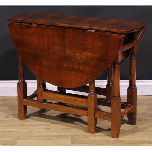 1278 - A 17th century style fruitwood gateleg table, oval top with fall leaves, turned and blocked supports... 