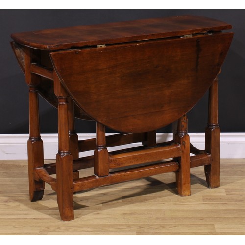 1278 - A 17th century style fruitwood gateleg table, oval top with fall leaves, turned and blocked supports... 