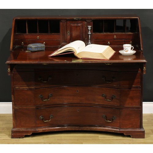 2201 - An unusual George III mahogany bureau, fall front enclosing a small door, small drawers, pigeonholes... 