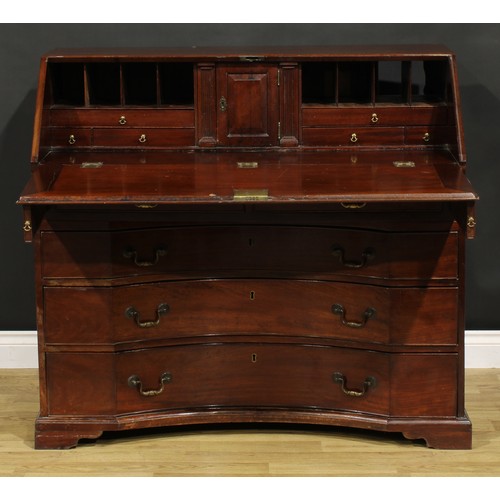 2201 - An unusual George III mahogany bureau, fall front enclosing a small door, small drawers, pigeonholes... 