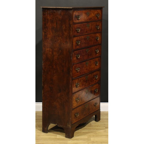 1565 - An unusual 18th century walnut and burr elm chest, of eight long drawers, brass swing handles, shape... 