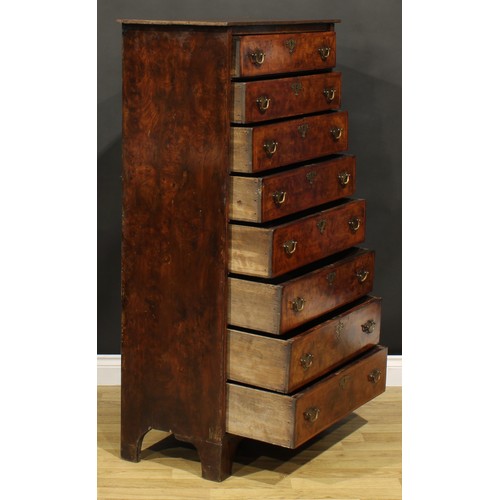 1565 - An unusual 18th century walnut and burr elm chest, of eight long drawers, brass swing handles, shape... 