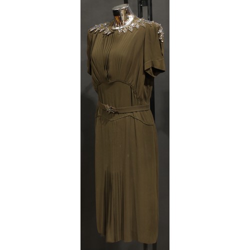 2544 - Vintage Fashion - A Norman Hartnell silk crepe dress, in khaki green/brown, the shaped collar accent... 