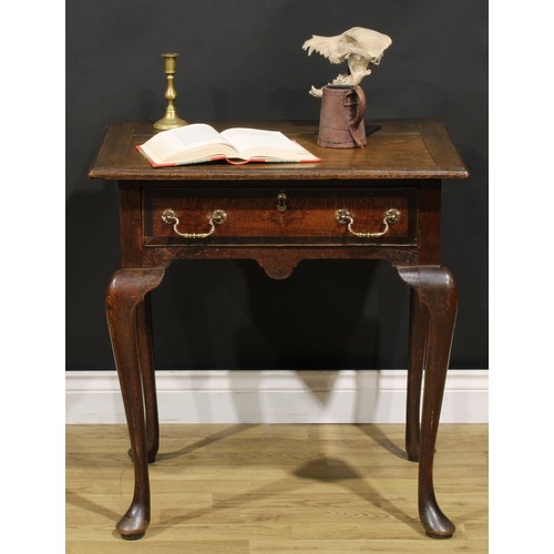 1525 - A 19th century oak side table, oversailing top above a long frieze drawer, shaped apron, cabriole le... 