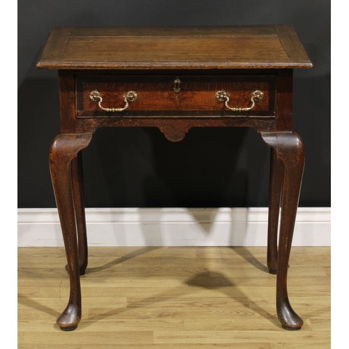 1525 - A 19th century oak side table, oversailing top above a long frieze drawer, shaped apron, cabriole le... 