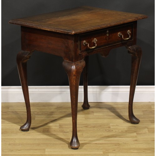 1525 - A 19th century oak side table, oversailing top above a long frieze drawer, shaped apron, cabriole le... 