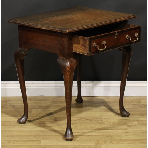 1525 - A 19th century oak side table, oversailing top above a long frieze drawer, shaped apron, cabriole le... 