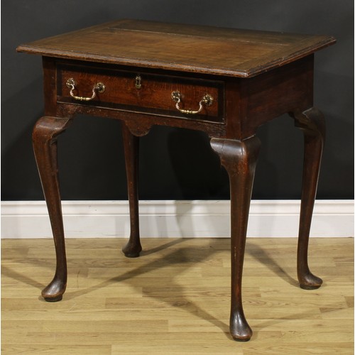 1525 - A 19th century oak side table, oversailing top above a long frieze drawer, shaped apron, cabriole le... 