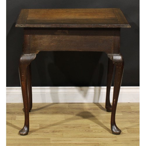 1525 - A 19th century oak side table, oversailing top above a long frieze drawer, shaped apron, cabriole le... 