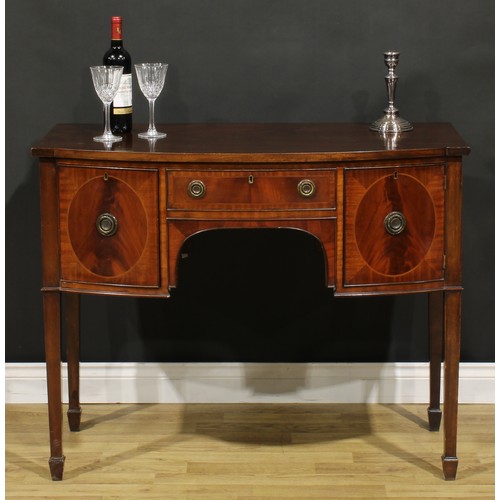 2127 - An Edwardian Regency Revival mahogany bow-centre sideboard or serving table, slightly oversailing to... 