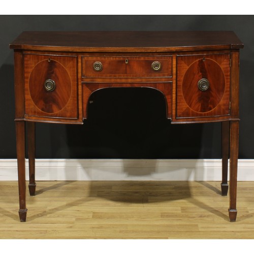 2127 - An Edwardian Regency Revival mahogany bow-centre sideboard or serving table, slightly oversailing to... 