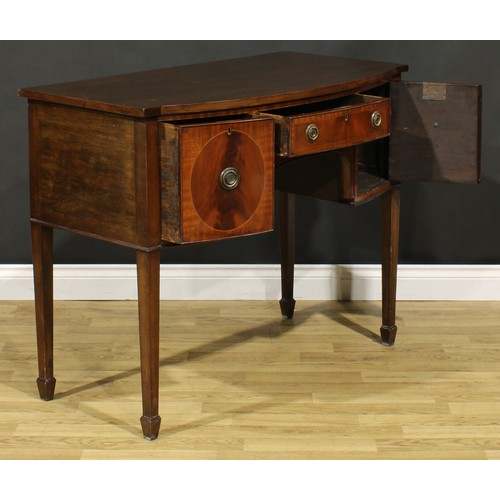 2127 - An Edwardian Regency Revival mahogany bow-centre sideboard or serving table, slightly oversailing to... 