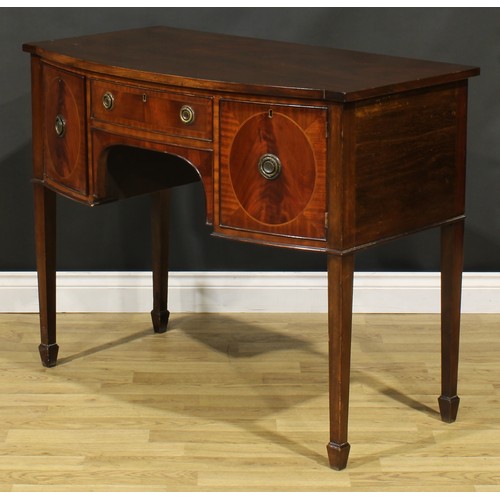 2127 - An Edwardian Regency Revival mahogany bow-centre sideboard or serving table, slightly oversailing to... 