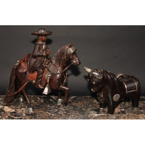 2181 - A Peruvian Fernando Castro silver mounted carved hardwood figure, child riding a Goucho style horse,... 