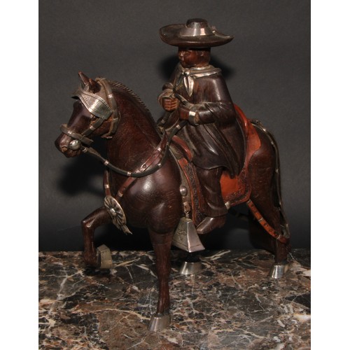 2181 - A Peruvian Fernando Castro silver mounted carved hardwood figure, child riding a Goucho style horse,... 