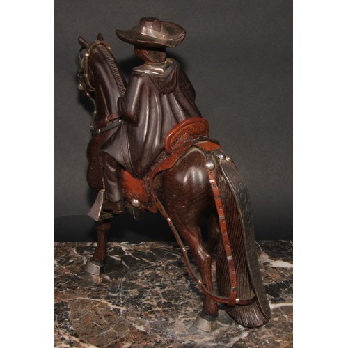 2181 - A Peruvian Fernando Castro silver mounted carved hardwood figure, child riding a Goucho style horse,... 