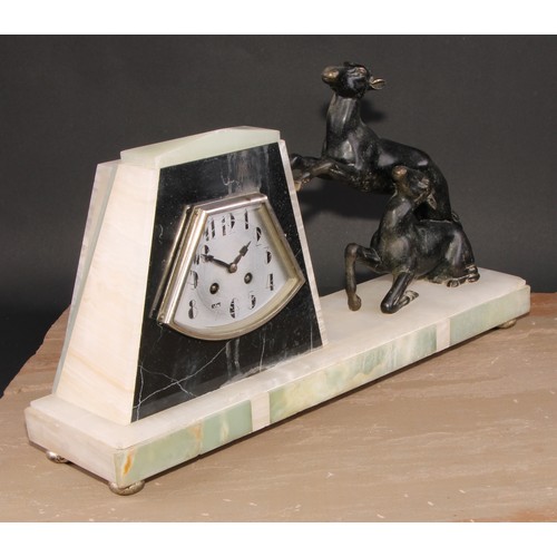 1312 - A French Art Deco bronze mounted mantel clock, in the manner of Uriano, eight day movement striking ... 