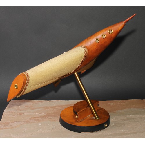 2076 - A mid-20th century brass-accented beech table lamp, as a rocket-powered aircraft, parcel-ebonised ci... 