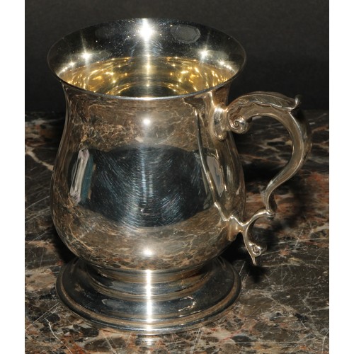 804 - An Elizabeth II silver bell shaped mug, of George II design, quite plain, acanthus-capped double scr... 