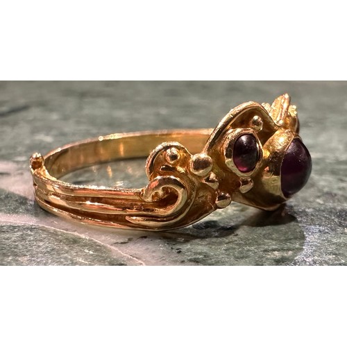 926 - An 18ct gold garnet ring, set with three circular cabochon red garnets, shaped scrolling crest, 18ct... 