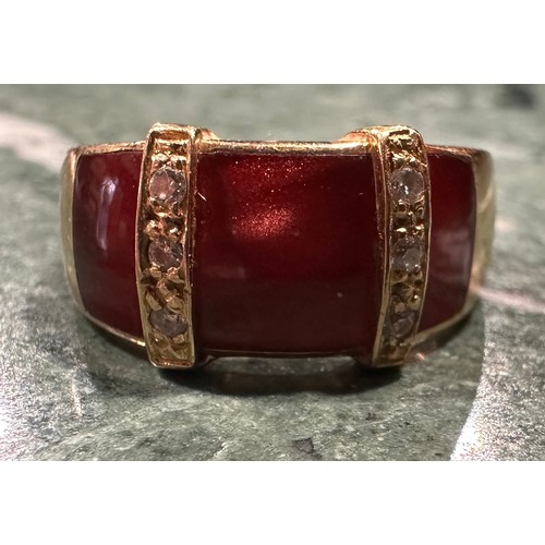 892 - A French diamond and ruby red chatoyant enamel dress ring, with three ruby red sections divided by r... 