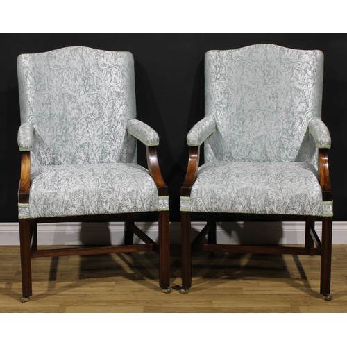 2107 - A pair of George III mahogany Gainsborough chairs, stuffed-over upholstery, internally-chamfered mou... 