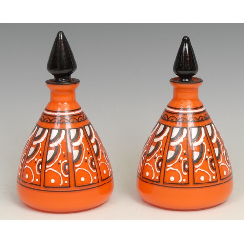 321 - A pair of Loetz type conical scent bottles, monochrome enamelled in panels, on an orange ground, bla... 