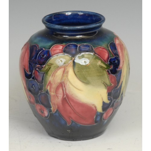 29 - A Moorcroft Leaf and Berry pattern baluster vase, 20cm high, script signature, impressed marks; anot... 