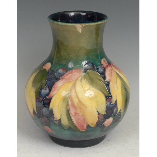 29 - A Moorcroft Leaf and Berry pattern baluster vase, 20cm high, script signature, impressed marks; anot... 