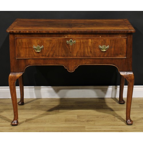 2070 - A George II walnut side table, crossbanded and featherbanded top with reentrant foreangles above a l... 