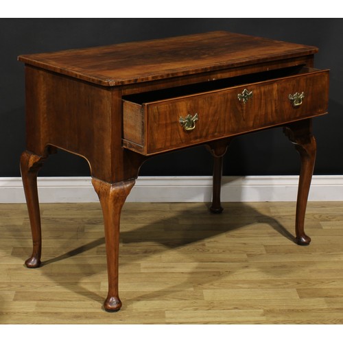 2070 - A George II walnut side table, crossbanded and featherbanded top with reentrant foreangles above a l... 