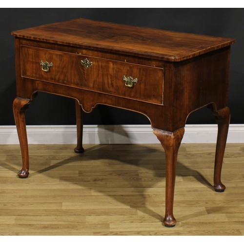 2070 - A George II walnut side table, crossbanded and featherbanded top with reentrant foreangles above a l... 