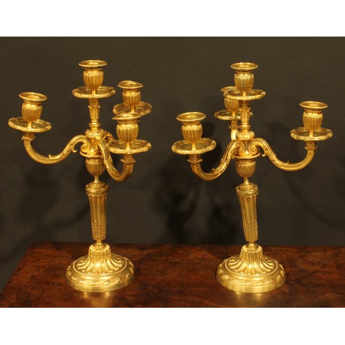 2145 - A pair of Louis XVI Revival gilt bronze four-light candelabra, by H. Voisenet, 61 Rue De Turenne, Pa... 