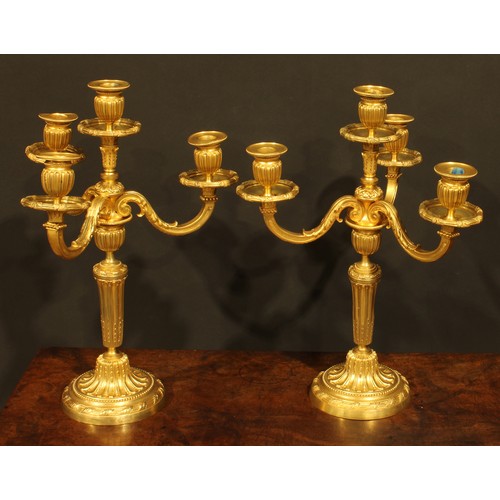 2145 - A pair of Louis XVI Revival gilt bronze four-light candelabra, by H. Voisenet, 61 Rue De Turenne, Pa... 