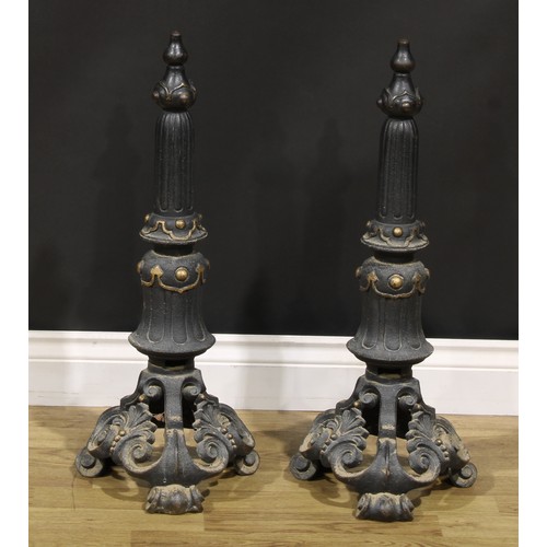 2105 - A pair of cast iron country house andirons, cast with foliate motifs, scroll feet, 67cm high