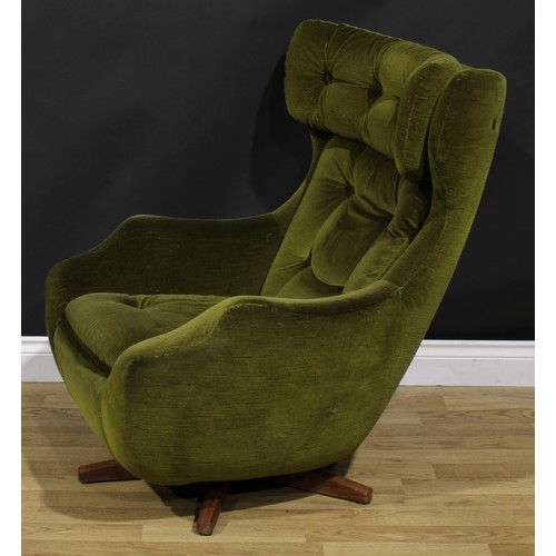 1544 - A Parker Knoll Statesman tilt and swivel lounge chair, stuffed-over upholstery, squab cushion, teak ... 