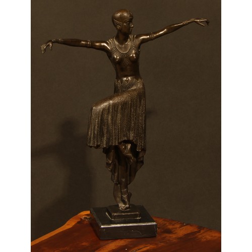 1640 - An Art Deco style dark patinated bronze, dancing girl in flapper dress and cap, arms outstretched, c... 