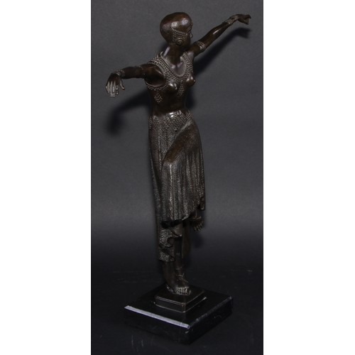 1640 - An Art Deco style dark patinated bronze, dancing girl in flapper dress and cap, arms outstretched, c... 