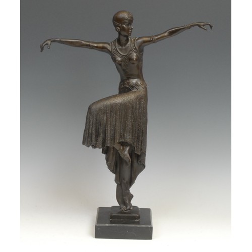 1640 - An Art Deco style dark patinated bronze, dancing girl in flapper dress and cap, arms outstretched, c... 