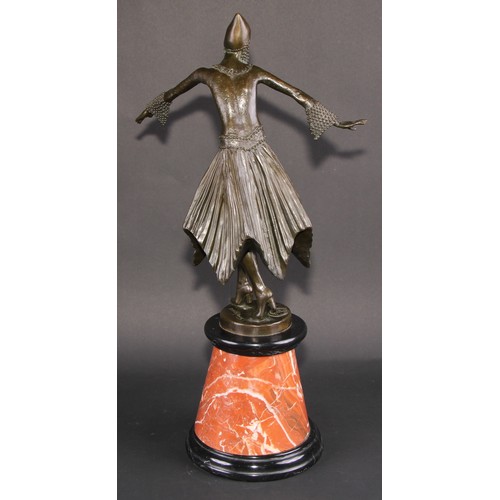 1639 - An Art Deco style dark patinated bronze, after Demétre Chiparus, dancing girl in cap with swirling s... 