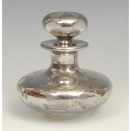 2118 - An Art Nouveau silver overlaid clear glass scent bottle, compressed ovoid form, conforming globular ... 