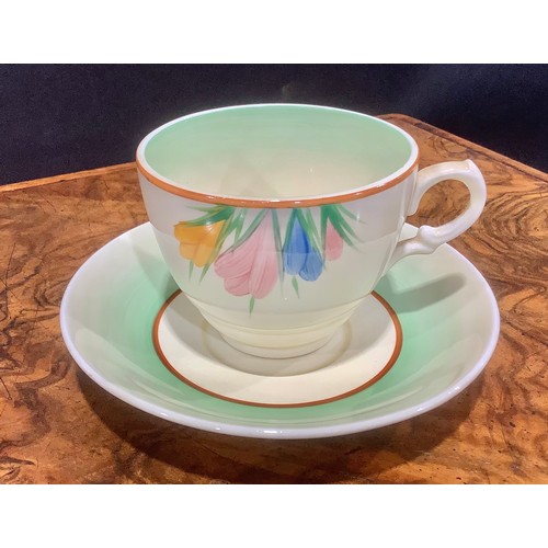 2 - A Clarice Cliff Bizarre Spring Crocus pattern teacup and saucer; another painted with coloured bands... 