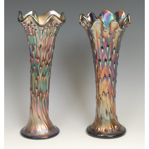 76 - A near pair of amethyst carnival glass trumpet shaped vases, 36cm; two similar smaller matched pairs... 