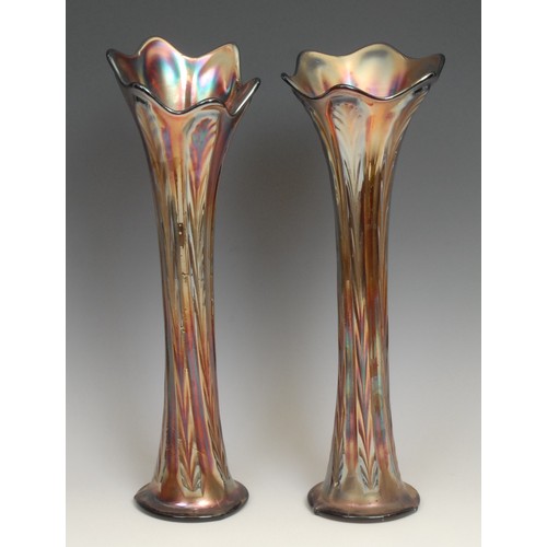 76 - A near pair of amethyst carnival glass trumpet shaped vases, 36cm; two similar smaller matched pairs... 